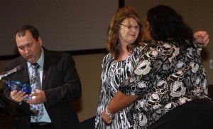 Barbara Weatherford hugs Victims Assistance Coordinator Franchelle Daniels as Diamondhead Police Chief and former Gulfport Police Chief Alan Weatherford presents Daniels with a special award during the National Crime Victims' Rights Week ceremony in Gulfport on Thursday. The Weatherfords lost their daughter to a drunken driver in 2011. JOHN FITZHUGH — SUN HERALD